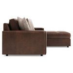 Side profile of sectional focusing on the chaise lounge and flanged stitched edges of leather