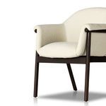 Profile shot with emphasis on armrest curve and fabric stitching detail