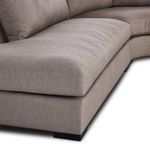 Close-up of thick seat cushion with visible stitching on taupe fabric