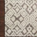 Corner of Neda Natural Ivory rug placed on dark hardwood floor highlighting pile texture and pattern contrast