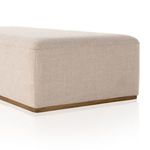 Top corner close-up highlighting tight fabric weave and precise upholstery on ottoman