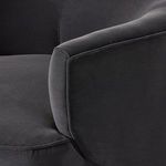 Close-up emphasizing fabric texture and tight stitching along armrest seam