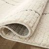 Corner of Fabian Ivory / Charcoal Rug rolled back revealing tightly woven underside