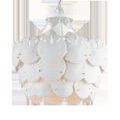 Tulum Chandelier viewed from lower angle displaying underside curves of sand dollars and soft light glow