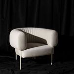 Reina Accent Chair styled in moody black fabric background enhancing its sculptural form and texture