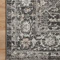 Close-up corner section on wood floor emphasizing floral border design and muted charcoal and silver tones
