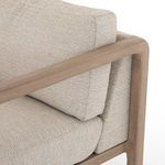 Detail of cushion corner seam where beige backrest and seat cushions meet