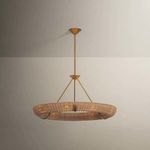 Chandelier illuminated with soft yellow light against two-tone gray walls