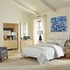 Maila Lamp styled on bedside tables in a bright bedroom with white and blue decor accents