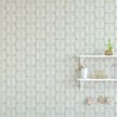 Wallpaper with seagrass botanical pattern in a child's room with white shelves and wooden floor