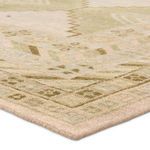 Close-up angled view showing the rug's distressed texture and detailed hand-knotted fibers