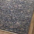 Section of rug on floor focusing on fading and subtle color variations near edge