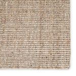 Close-up showing detailed woven fibers and texture of tan and black Sutton area rug