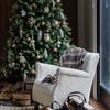 Full view of holiday room featuring a Christmas tree decorated with the owl sculptures and rustic ornaments next to a whit...