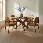 Norrie dining chairs set around a round wood dining table in bright modern dining room