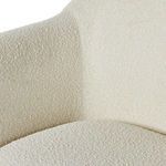 Top edge of backrest with smooth rounded contours and plush cream fabric