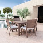 Outdoor dining set including Laguna Dining Chairs and rectangular table on stone patio by pool