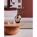 Close-up side angle highlighting the wood texture on the rounded base and vase with flowers placed on the tabletop