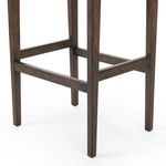 Close-up detail of black leather seat's clean edge seam on Aya Stool
