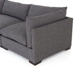 Detailed corner view of sofa showing thick seat cushion and overlapping back pillow in charcoal