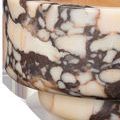 Close-up detail showing the dark and light veining on the bowl’s side surface