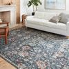 Cassandra Blue / Rust Rug in a modern living room setting with white sofa and wooden floor
