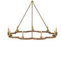 Close perspective of frame’s rattan texture and gold leaf candle cup holding a clear bulb