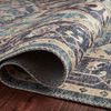 Curled edge of Hathaway Navy Multi Rug revealing woven polyester texture and underside.