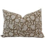 Brown block print pillow cover with beige floral and leaf patterns on textured fabric