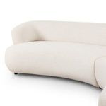 Close-up of front corner cushion area showing texture and curved seat design