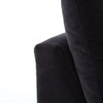Back view showing deep charcoal fabric and two loose cushions on corner sectional