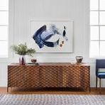 Close-up view of Carbon By Beth Winterburn painting in modernly styled room with textured sideboard and natural light