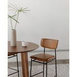 Sailor Stool next to wooden table with vase and cup, setting in a modern minimalist room
