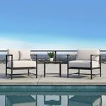 Two Pietra Club Chairs in off-white cushions by poolside with cityscape background