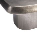 Close-up of the textured edge and corner curve on the graphite top of Clawson cocktail table