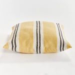 Side view of pillow lying flat, showing thickness and striped woven texture