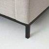 Close-up of black iron leg base angled at sectional sofa corner