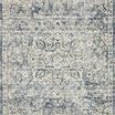 Full top view of ivory and blue rug featuring detailed symmetrical medallion and border design