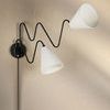 Black Onda sconce close-up of switch on round mounting plate and cord extension
