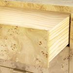 Open drawer slide showing smooth pine interior contrasting burl wood front