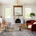 Margot rug styled in bright living room with rust velvet sofa and modern chairs