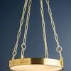 Chandelier illuminated against dark blue background, highlighting aged brass finish
