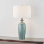 Bellmawr Table Lamp turned on, showing warm light through white drum shade and a slight color variation on base