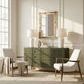 Dresser styled in bright room with white walls, armchairs, rug, mirror, and lamps