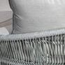 Close-up of light grey cushioned fabric texture with rope frame in soft natural lighting
