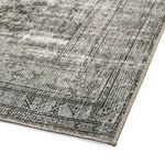 Rug corner at an angle highlighting woven texture and stitched border