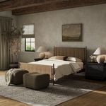 Richard Bed styled in a rustic bedroom setting with neutral linens, dark nightstands, and soft lighting