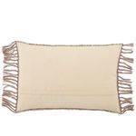 Reverse side of lumbar pillow in solid taupe fabric with tasseled edges