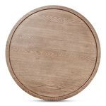 Overhead close-up highlighting circular tray rim and wood grain pattern on table top