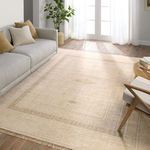 Beige and cream medallion rug styled in a sunlit living room with sofa, chair, and hardwood floor